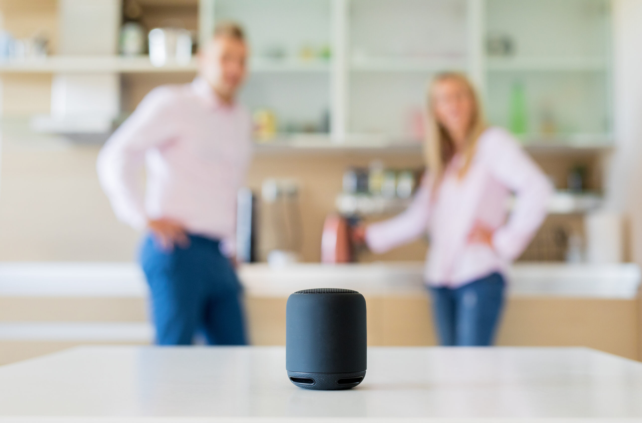 Couple using smart speaker at home women at an ATM in bank