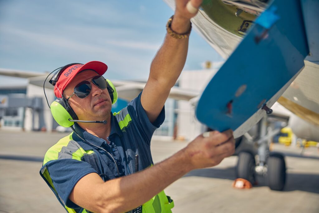 front-view-serious-maintenance-technician-sunglasses-carrying-out-aircraft-inspection-outside (1)